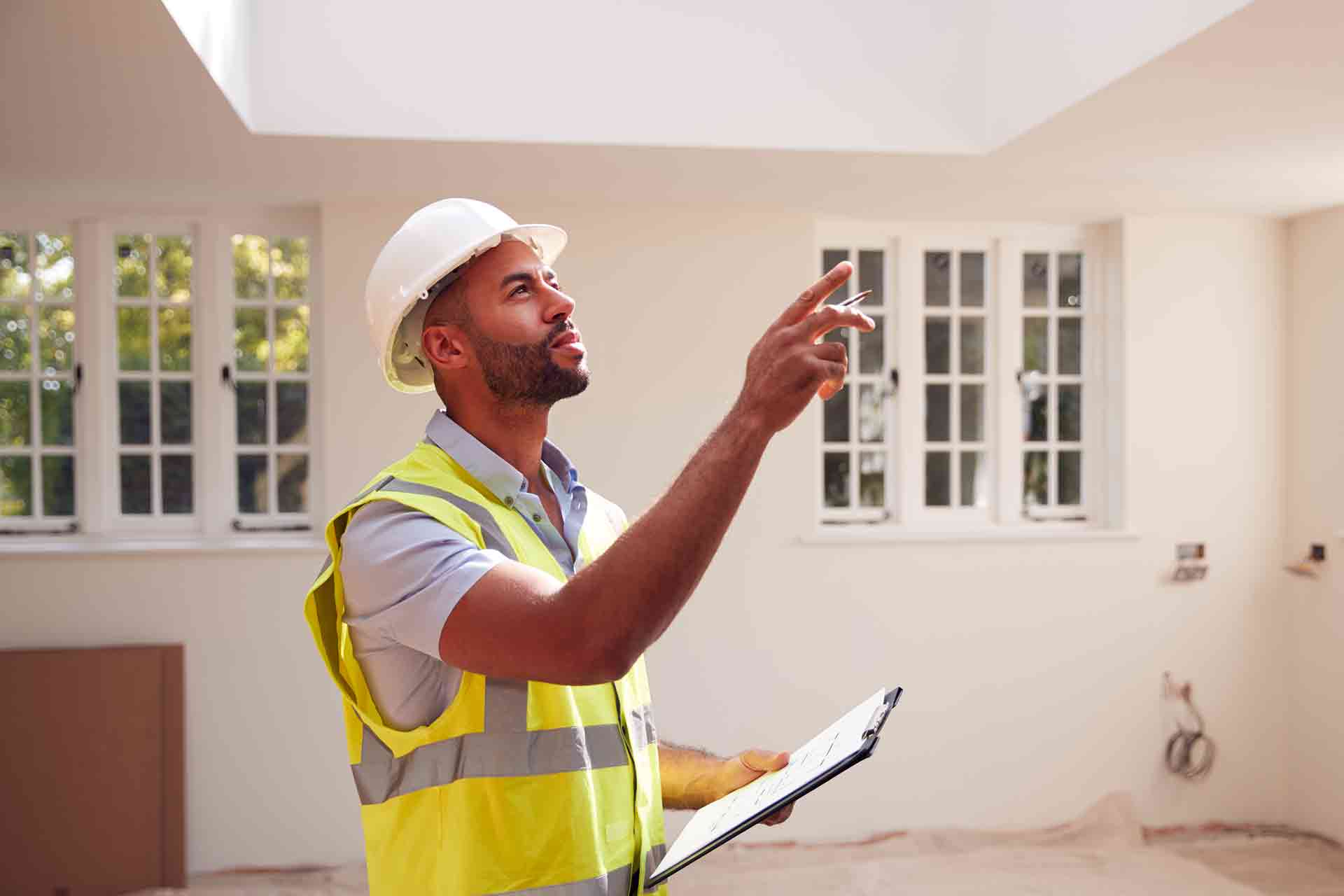 Third Party Wall Surveyors Wandsworth reviewing plans between two parties during a dispute